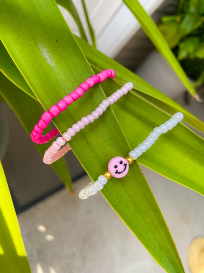 Pink smiley face bracelet stack