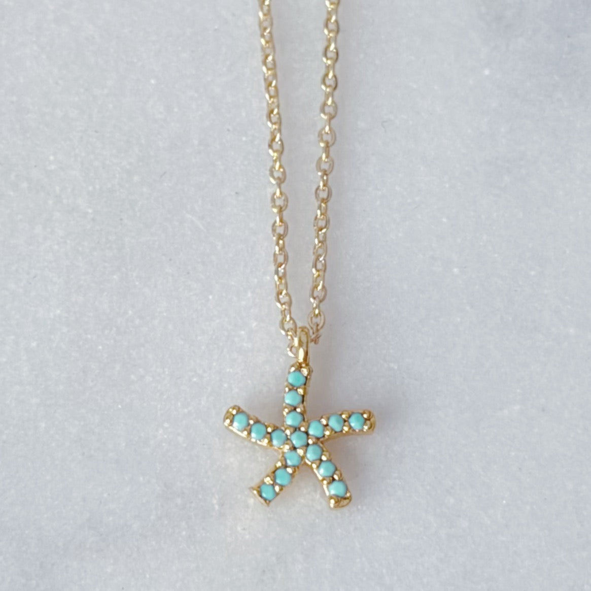 Dainty turquoise gem paved gold starfish necklace