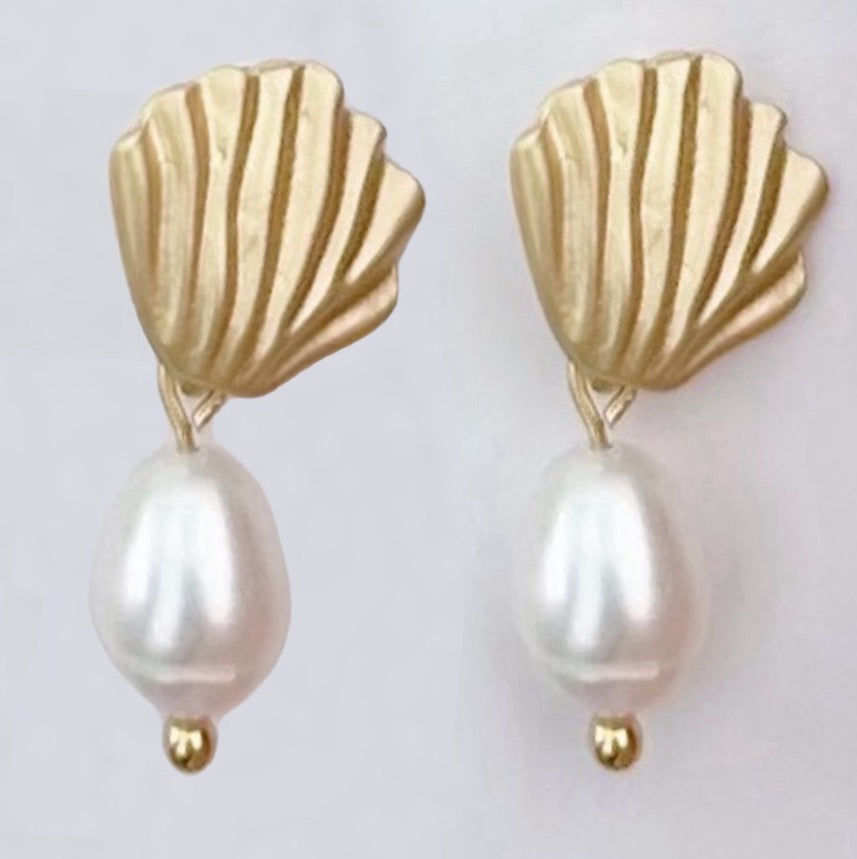 Gold seashell and pearl earrings.