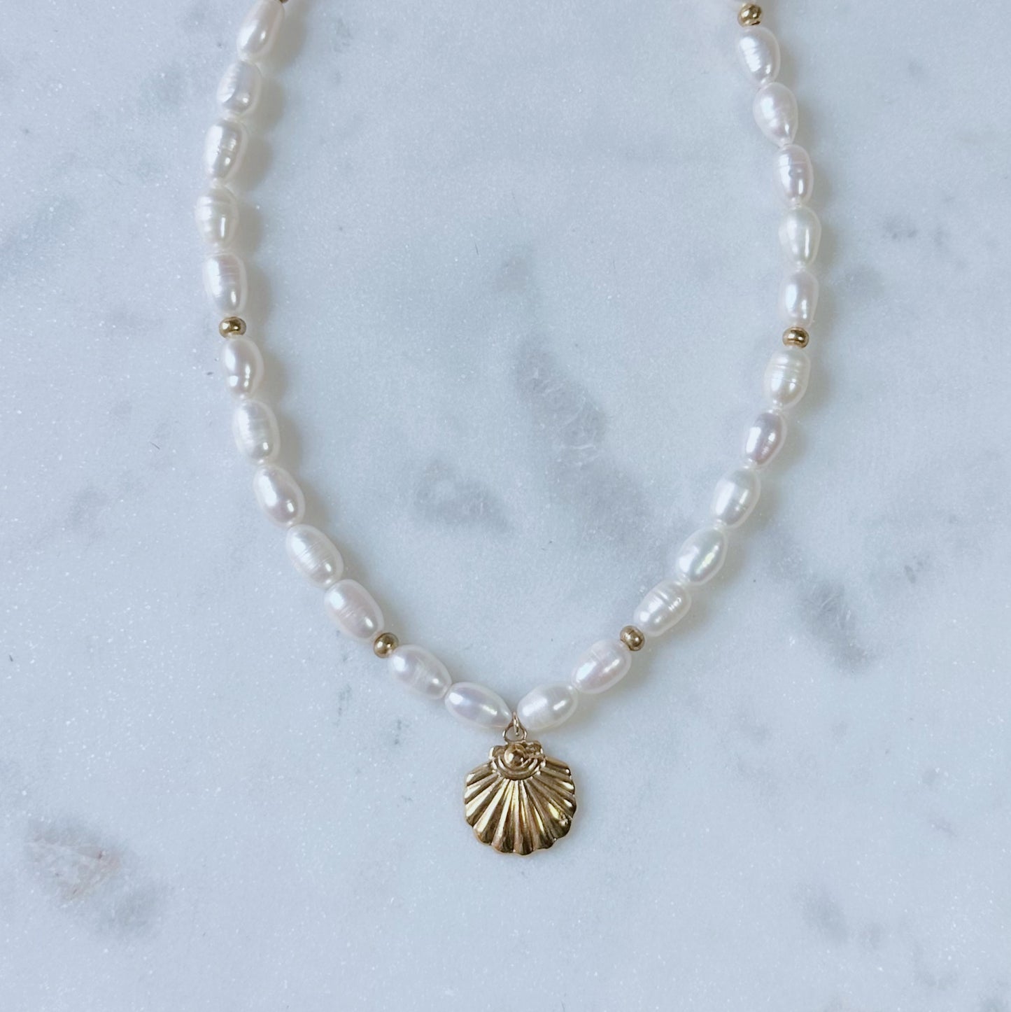 Chunky pearl & gold charm necklace