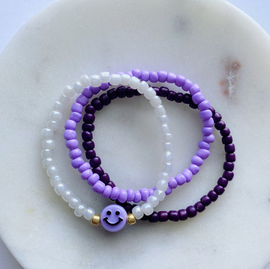 Purple smiley bracelet stack