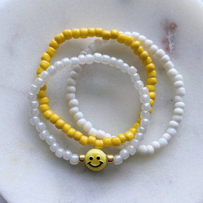 Yellow smiley bracelet stack