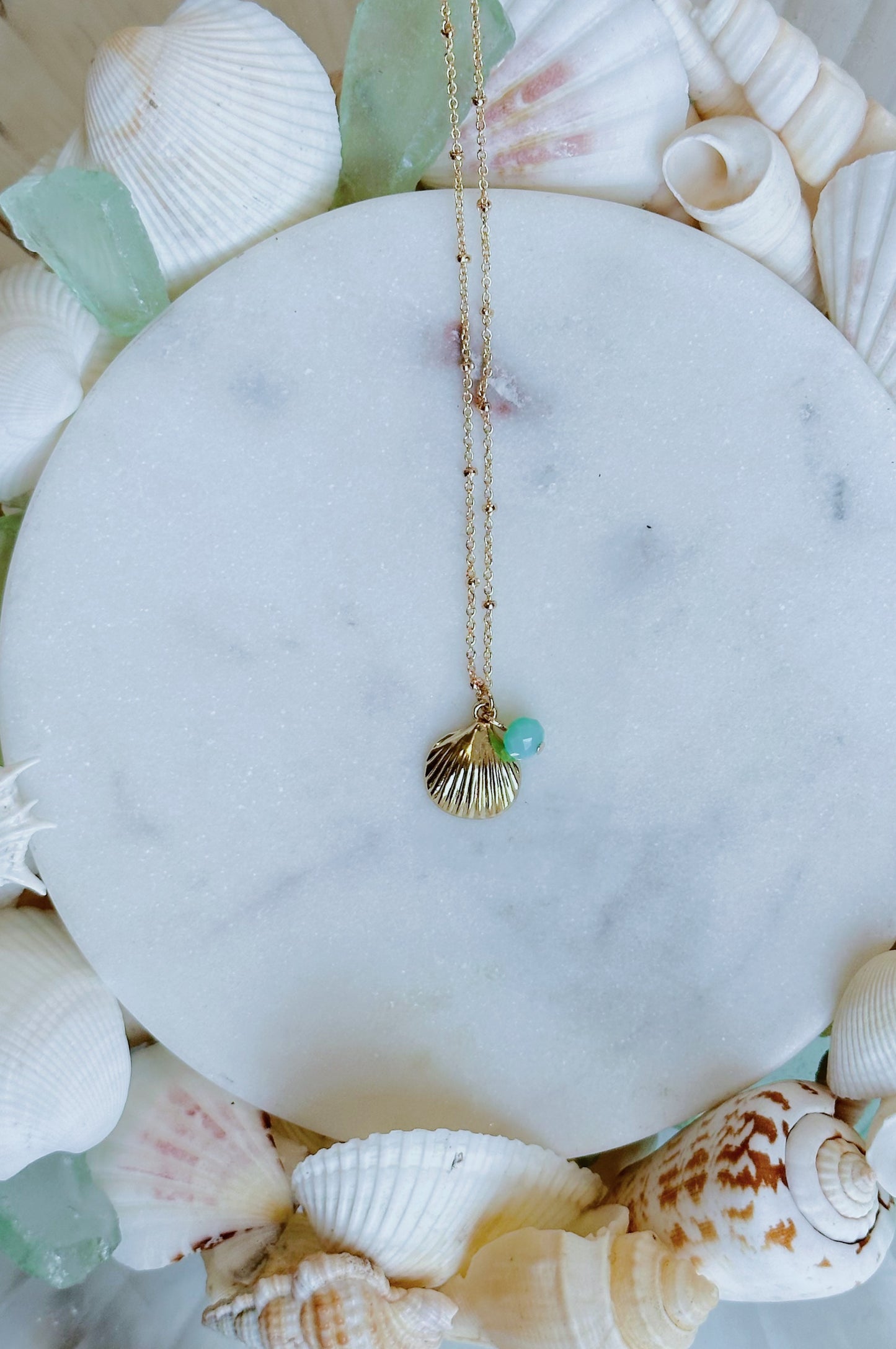 Gold seashell and turquoise gem necklace