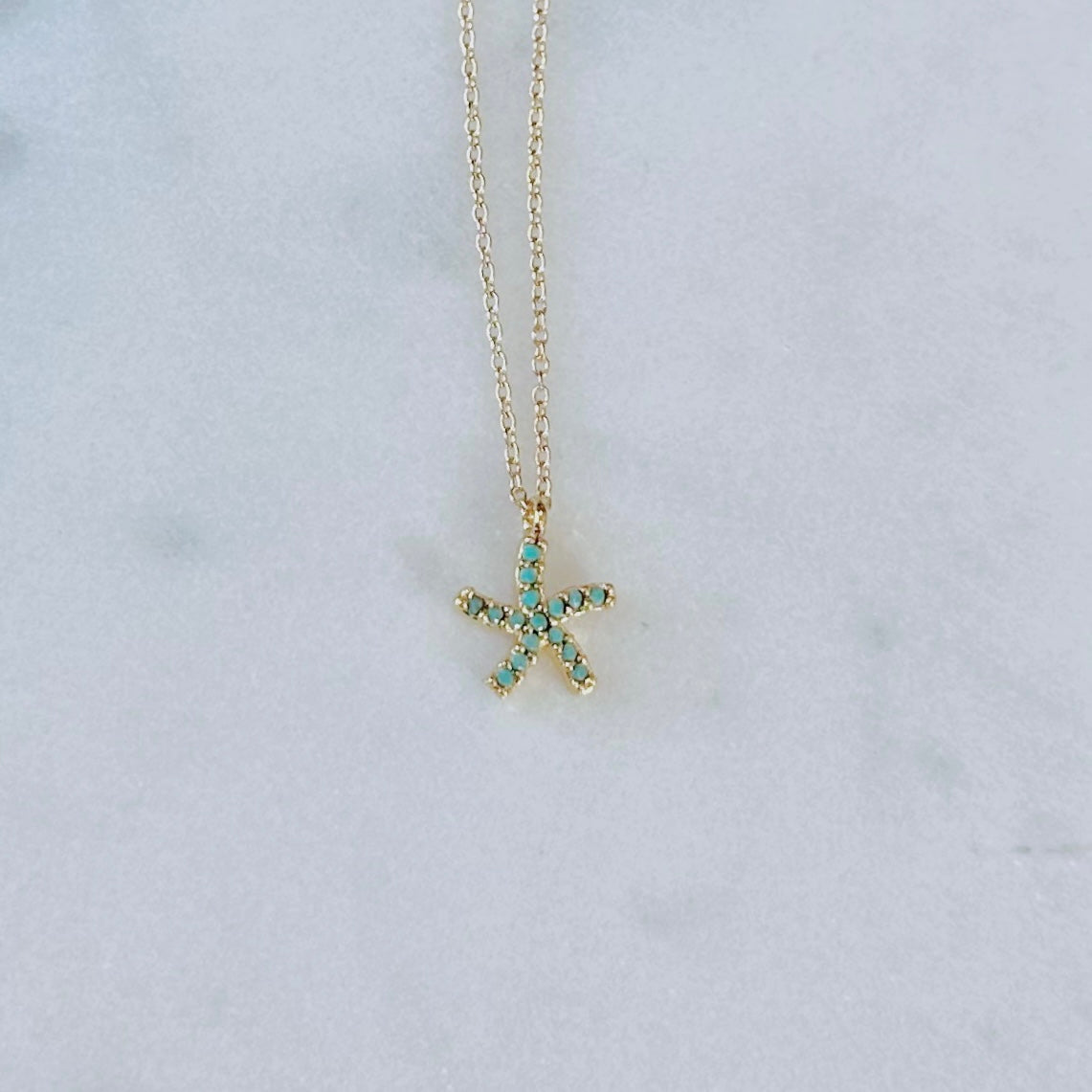 Dainty turquoise gem paved gold starfish necklace